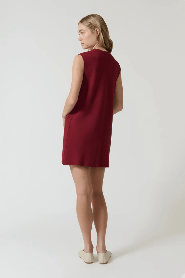 Nanda Dress Burgundy by Onte – Trendy sleeveless shift in heavy Milano knit with gold knot buttons, flattering A-line silhouette, perfect for chic day or night looks.
