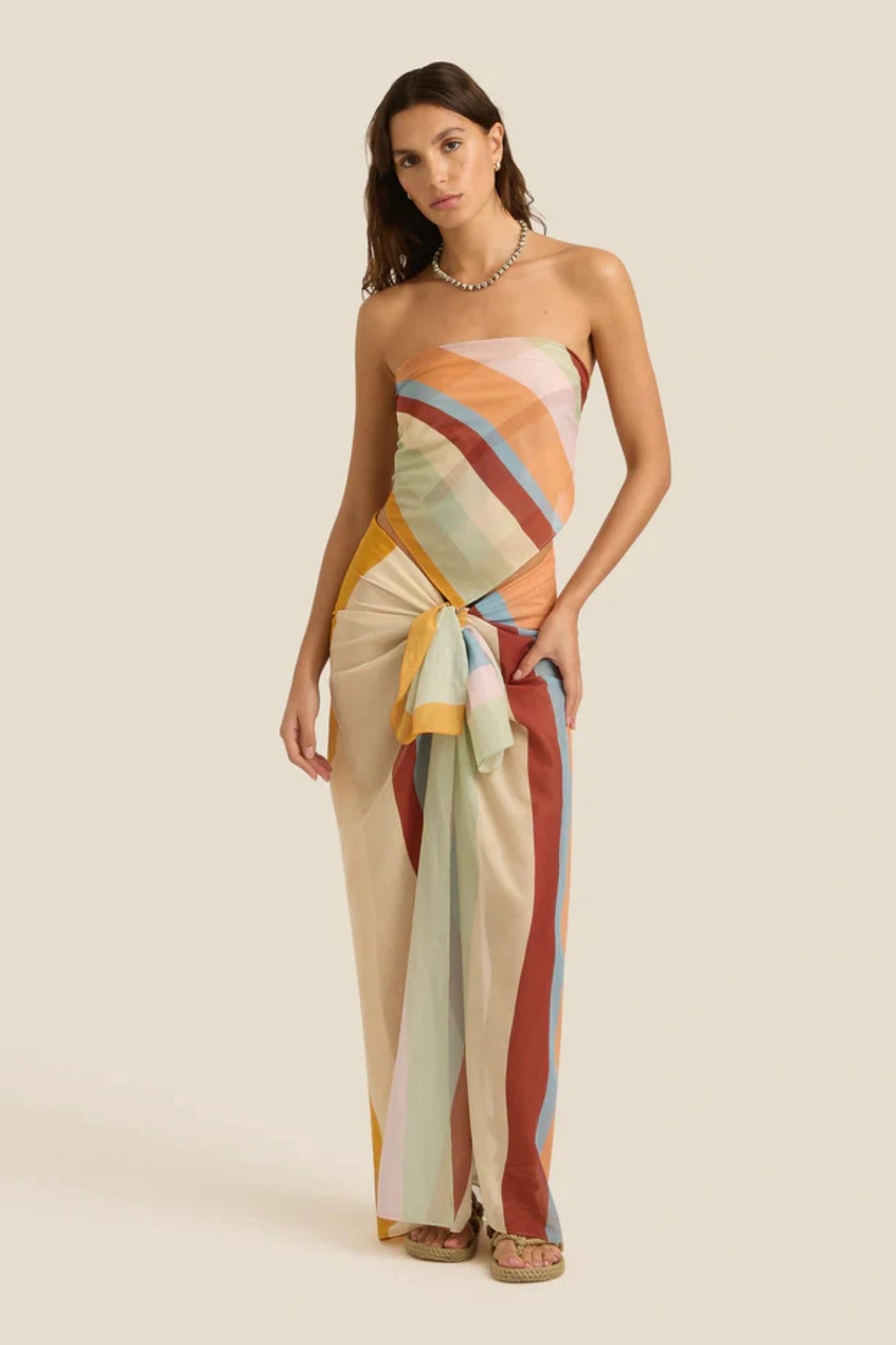 Square Pareo in Iris by Soleil Soleil, a versatile organic cotton wrap or scarf with rainbow-hued stripes, perfect for relaxed resort days.