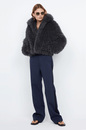 Argo Jacket Charcoal by Bec + Bridge – A chic charcoal faux fur bomber with wide collar, relaxed fit, front hook closure, and low waist finish. Fully lined. Dry clean only.