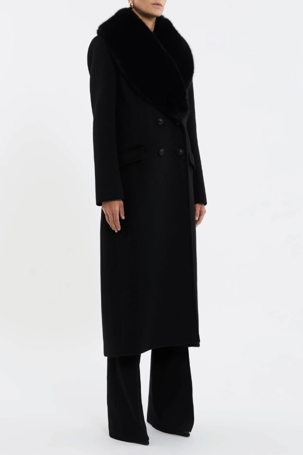 Biera Coat Black by Rebecca Vallance – A boxy, double-breasted wool coat with flap pockets, embossed dome buttons, and removable faux fur trim. Fully lined for comfort.