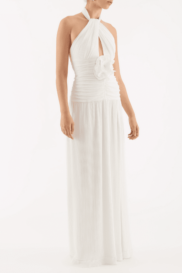 Guinevere Halter Gown Ivory by Rebecca Vallance – Halter gown with ruched waist, floral applique, open back, and front split.