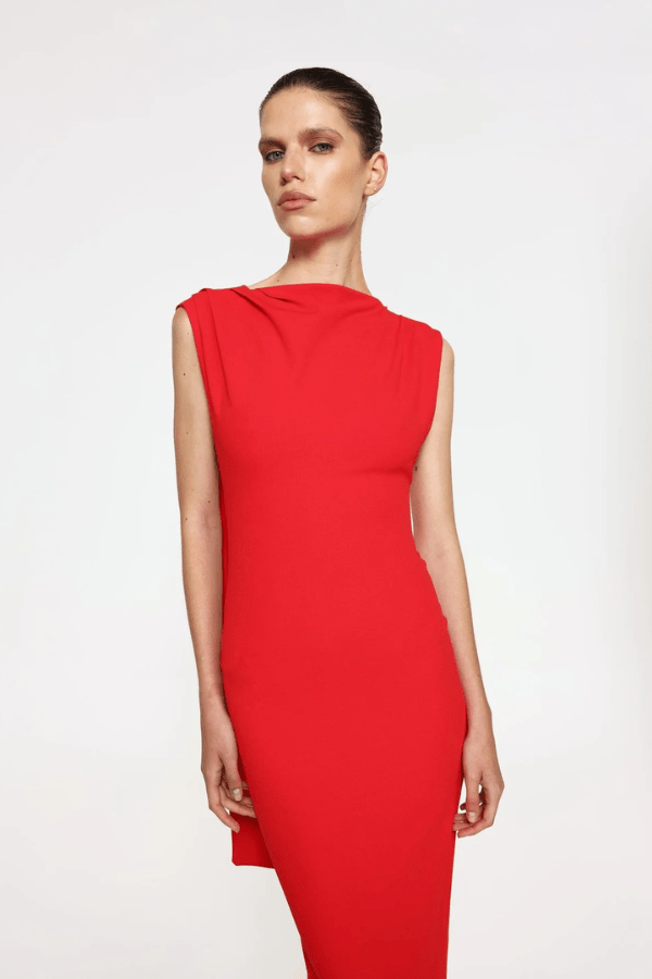 Audrey Gown Cherry Red by Effie Kats – A chic stretch crepe gown with a straight neckline, exaggerated low back, and elegant over-the-shoulder detail, perfect for special occasions.