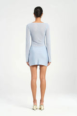 Faris Mini Dress Sky by Benni, featuring a boat neckline, long sleeves, diamante mesh bodice, and asymmetrical skirt with side drape for a graceful silhouette. Ideal for elegant evening.