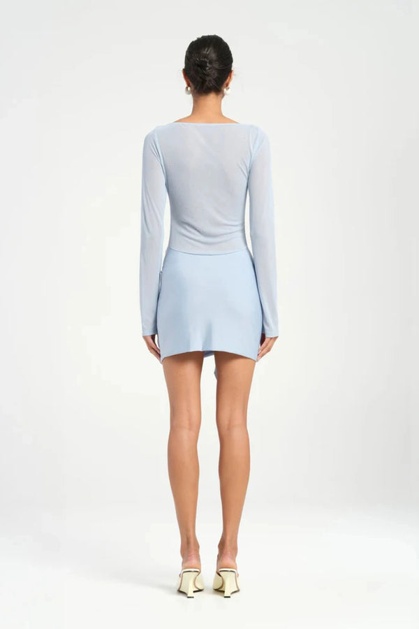 Faris Mini Dress Sky by Benni, featuring a boat neckline, long sleeves, diamante mesh bodice, and asymmetrical skirt with side drape for a graceful silhouette. Ideal for elegant evening.