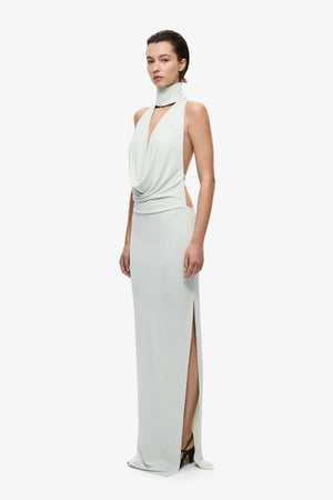 The Cowl Neck Jersey Dress by MISHA, halter cowl maxi with open back and side split for sleek evening styling.