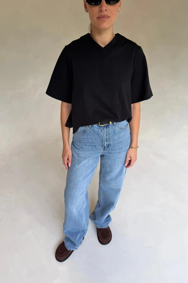 Black Olivia High V Neck Relaxed Tee with short sleeves and a loose fit on a plain background.