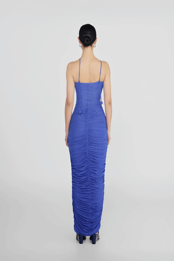Veranera Marino by Maygel Coronel – A sculptural, ruched mesh maxi with asymmetric floral cut-outs and delicate rosebud straps, perfect for elegant evenings and resort wear.