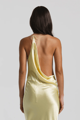 Gabi Gown Lemon by Natalie Rolt – A trendy bias-cut silk gown with an elegant asymmetric silhouette, open back, and delicate ties, perfect for special occasions.