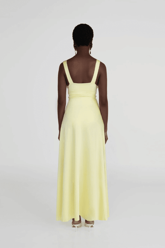 Orinoco Lime by Maygel Coronel – Maxi dress with deep V-neck, ruched bodice, 3D flowers, wide straps, and flowing skirt.