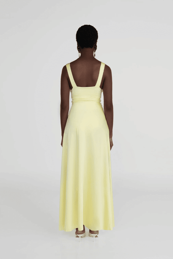Orinoco Lime by Maygel Coronel – Maxi dress with deep V-neck, ruched bodice, 3D flowers, wide straps, and flowing skirt.