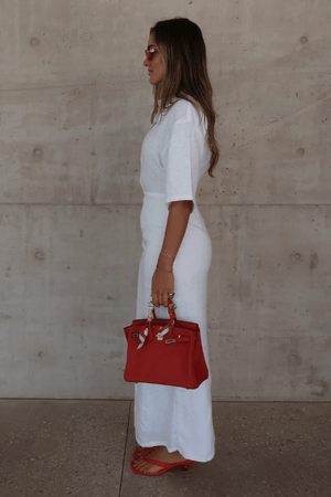 Lefka Midi Dress White by Sneaky Link – Breezy 100% linen midi with button-front and flattering tucks. Perfect for trendy summer strolls or viral lunch dates.