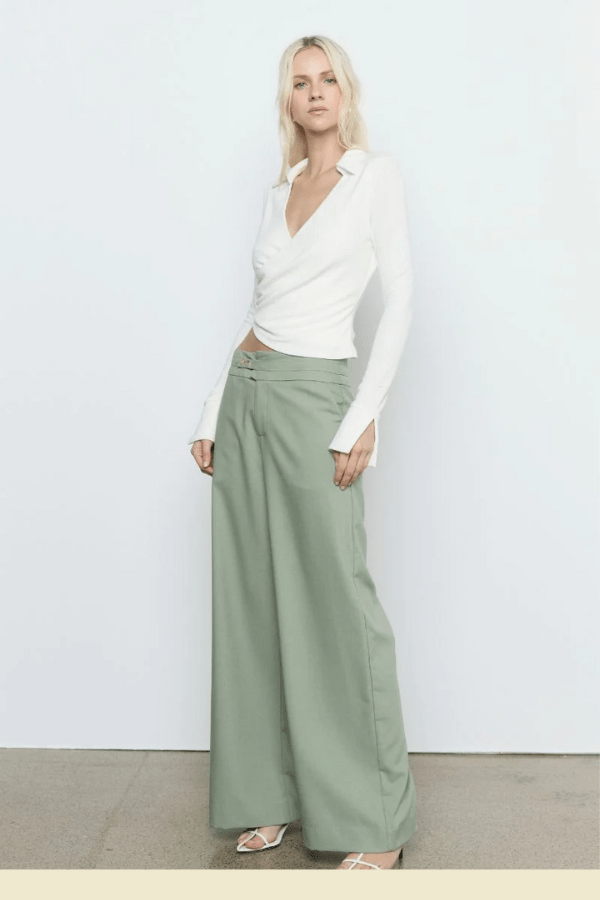 Emile Top White by Sovere — A fitted long-sleeve top in textured stretch fabric featuring a fixed wrap front, structured collar, wide split cuffs, and side gathers for a flattering silhouette. Fully lined for smooth wear and effortless sophistication.