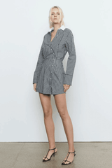 Laia Shirt Dress Black Stripe by Sovere Studio – A trendy cotton blend shirt dress with asymmetric placket, flattering waist tucks, and contrast collar. Perfect for casual to semi-formal looks.