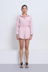 Pino Flared Short in Pink by Pfeiffer, mid-rise flared shorts with wide hem and leg-lengthening silhouette for effortless styling.
