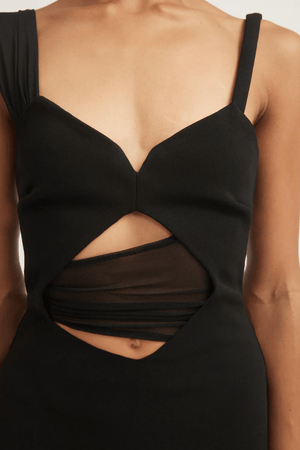 Madeleine Dress Black by Tojhà – A viral double-bonded crepe maxi with asymmetric straps, curved cut-out, and layered mesh, perfect for elegant evening events.