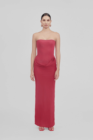 Campano Crimson by Maygel Coronel – A sleek strapless column dress with front twist draping and signature 3D floral detail, perfect for sophisticated evening events.