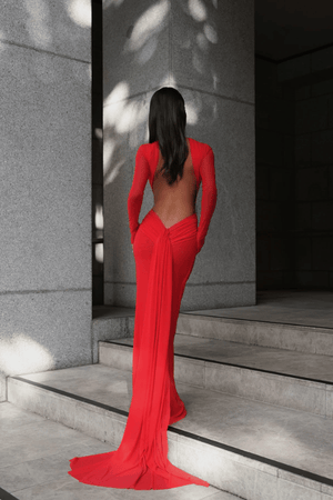 Monaco Gown Red by Effie Kats – Elegant soft mesh gown with high neckline, long sleeves, and daring open back, featuring ruching and crossed waist for a sculpted, timeless silhouette.