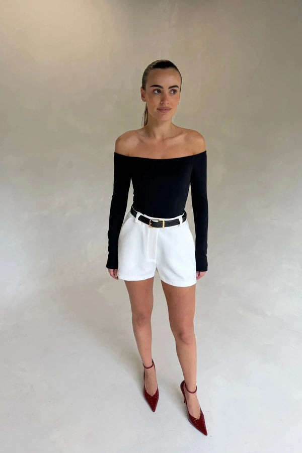 Black Henley long sleeve bodysuit with an off-shoulder neckline and fitted silhouette.