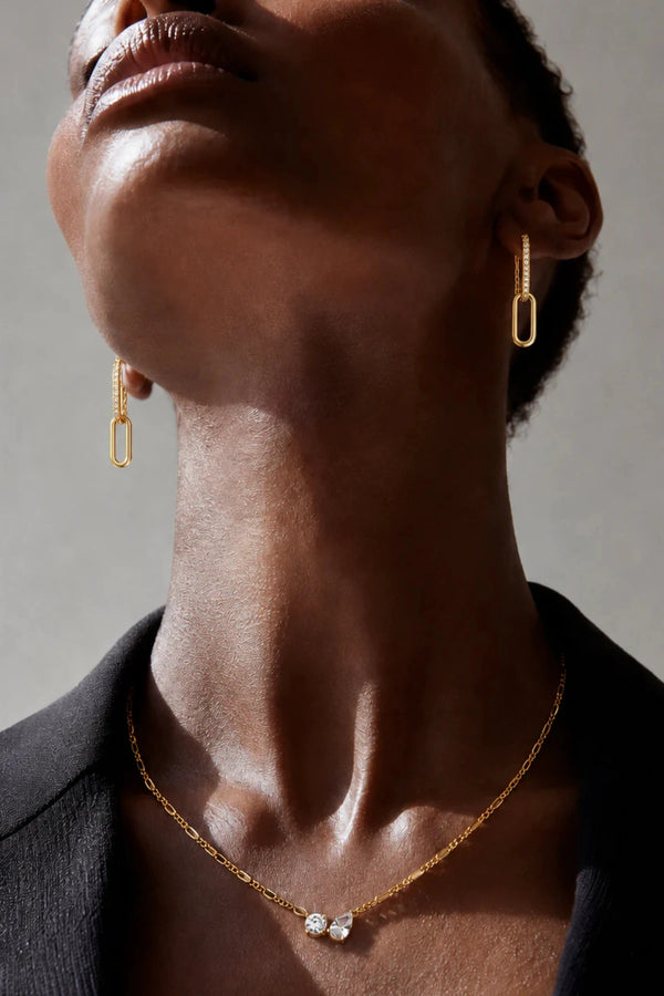 Twin Flame Necklace by Avant Studio in 18k gold plated sterling silver with cubic zirconia and adjustable chain.