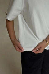 White Olivia High V Neck Relaxed Tee with short sleeves and a loose fit on a plain background.