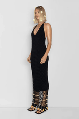 Reis Macrame Maxi Dress Noir by The Wolf Gang – Striking handmade black macrame dress with beaded hem, ideal for festivals or summer soirées.