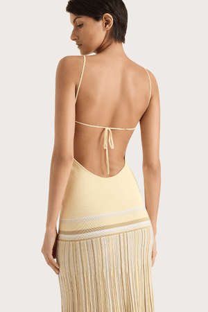 Citara Maxi Dress Butter Stripe by Faithfull the Brand – Trendy ribbed knit maxi with adjustable straps and backless tie, perfect for effortless summer elegance and beach days.