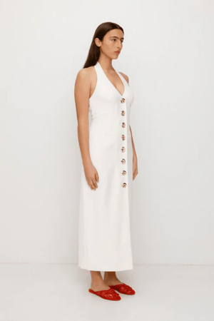 Irida Maxi Dress Ivory by The Wolf Gang – A trendy fitted maxi with halter neckline and gold swirl details, perfect for timeless elegance at special occasions.