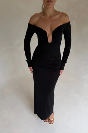 Black Haley off-shoulder midi dress with fitted bodice and flowy skirt, featuring short sleeves and a subtle slit.