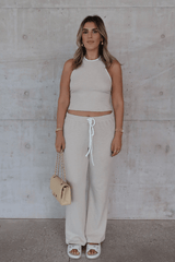 Charlie Pant Sand/White by Sneaky Link, trendy and comfortable low-rise pants with elastic waist and contrast drawcord, perfect for chic summer days and evenings.