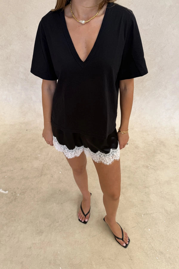 Lilah Short in black and ivory with a relaxed fit and mid-thigh length, styled on a neutral background.