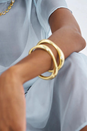 Cristabel Bangle by Avant Studio, a 5mm gold oval bangle with organic shape. Perfect for layering or everyday elegant wear.