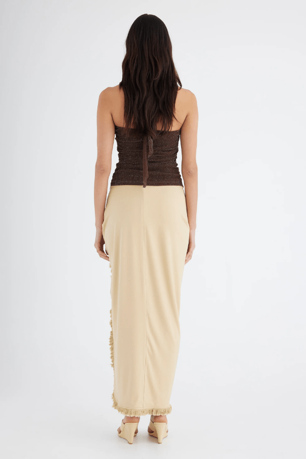 Bernie Fringe Skirt Butter by Benni — Midi skirt with mid-rise waist, front knot, side split, and fringe trim. Made from soft, comfortable jersey fabric.