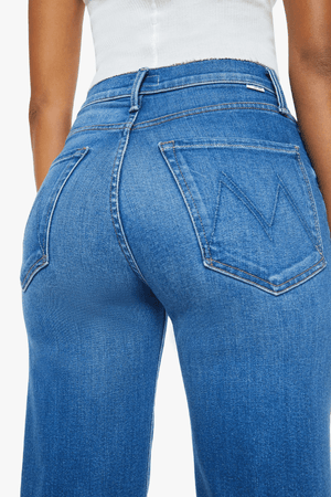 The Rambler Zip Flood Nip In The Bud by MOTHER, trendy high-rise jeans with a wide straight leg and cropped, clean hem. Perfect for a laid-back, polished look in mid-blue with subtle fading and whiskering.