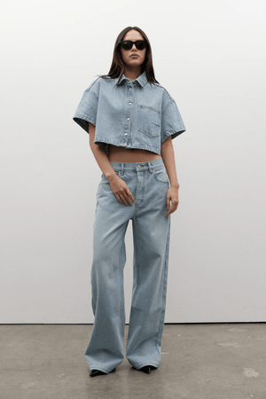 Zara Cropped Denim Shirt Oakland Blue by Bayse, a trendy cropped denim shirt with a relaxed fit and snap-button front. Perfect for effortless styling, whether paired with high-waisted denim or layered over a fitted tank.