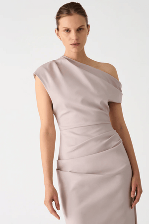 Gia Midi Dress Faded Silver by Misha – Designed in structured sateen, this midi features an asymmetric neckline and pleated shoulder detail.