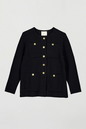 Helena Jacket Black by Onte – A stylish reinterpretation of the iconic Helena gilet, made from breathable 100% cotton yarn with a unique crochet-style stitch. Features a loose fit, gold Onte buttons, long sleeves, crew neck, and patch pockets.
