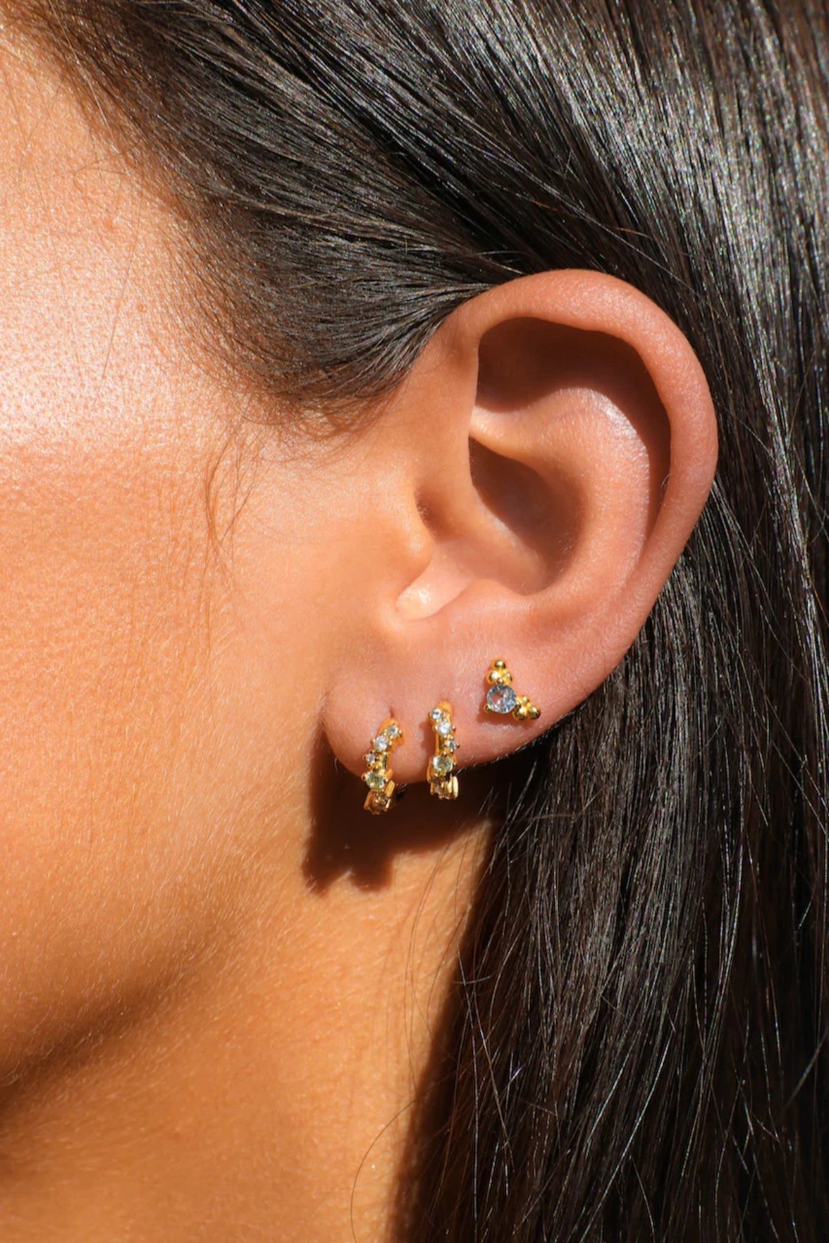 Jemima Huggies by Avant Studio, dainty gold hoops with pastel CZ gems. Perfect for subtle ear stacks and everyday styling.