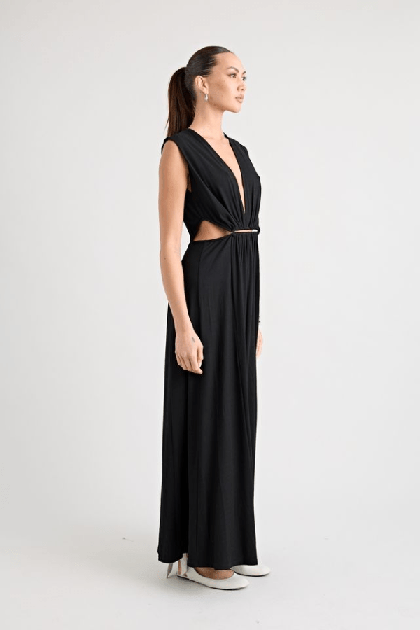 Do For Love Gown Black by Pfeiffer – A trendy, elegant low-plunge maxi with bold hardware and thigh-high split, perfect for special occasions and modern sophistication.