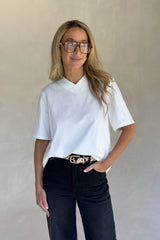 White Olivia High V Neck Relaxed Tee with short sleeves and a loose fit on a plain background.