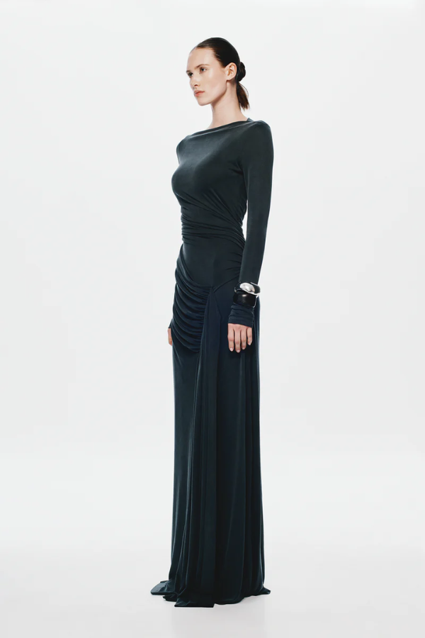 The 'Glacier' Long Sleeve Dress Black by MISHA, full-length black maxi with sculptural draping, high boat neckline, asymmetrical pleats, dry clean only.