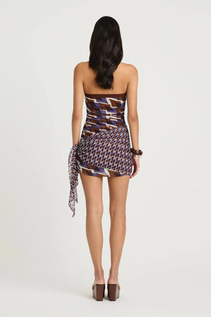 Marnie Mini Dress by Benni, a ruched halter mini with hip scarf tie in Terra Mosaic print. Perfect for summer events and vacations.