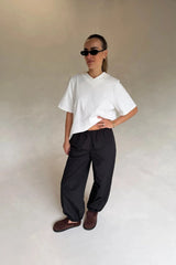 White Olivia High V Neck Relaxed Tee with short sleeves and a loose fit on a plain background.