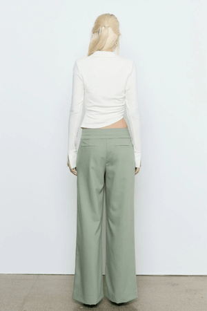 Emile Top White by Sovere — A fitted long-sleeve top in textured stretch fabric featuring a fixed wrap front, structured collar, wide split cuffs, and side gathers for a flattering silhouette. Fully lined for smooth wear and effortless sophistication.