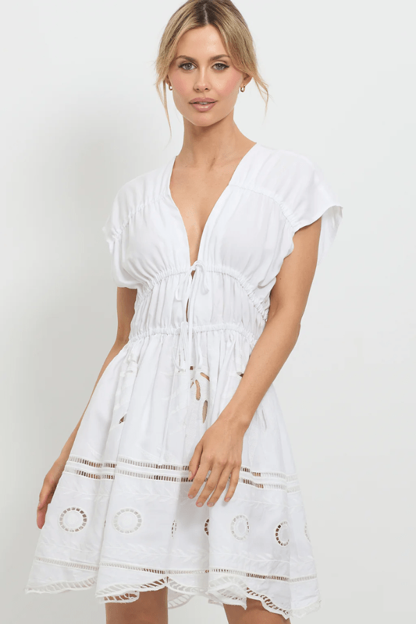 Sunrise Spirit Dress White by Pasduchas – A trendy, embroidered Tencel-linen blend dress with adjustable ties and scalloped hem, perfect for chic day-to-night occasions.