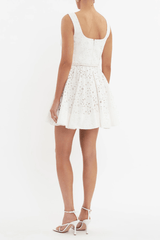 Nuvola Bustier Mini Dress Ivory by Rebecca Vallance – A chic broderie anglaise mini with sweetheart neckline, belted waist, and fitted bodice. Perfect for trendy daytime events or elegant summer parties.