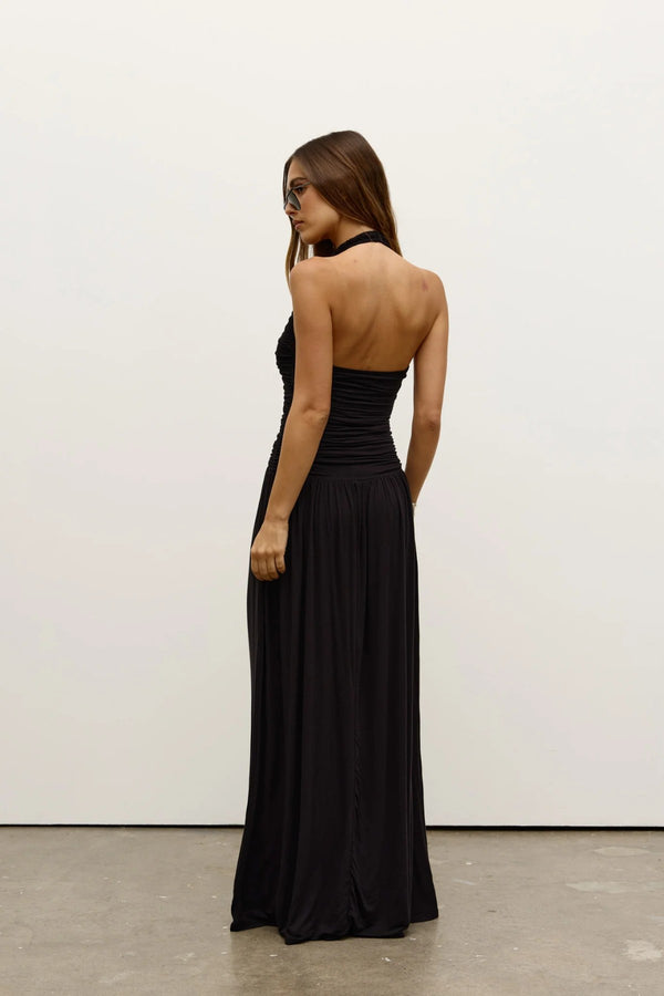 Frances Dress in Shadow by Bayse, a full-length ruched dress with a plunging halter neckline and open back for elevated evenings.