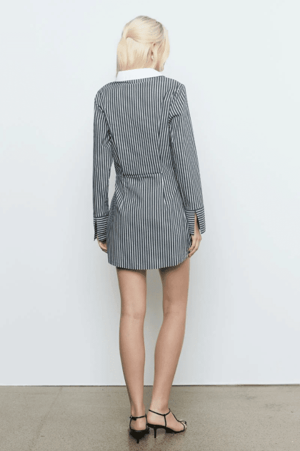 Laia Shirt Dress Black Stripe by Sovere Studio – A trendy cotton blend shirt dress with asymmetric placket, flattering waist tucks, and contrast collar. Perfect for casual to semi-formal looks.