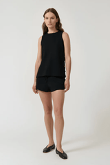 Anabel Top Black by Onte – Trendy A-line silhouette in heavy crepe knit with gold buttons, perfect for polished day-to-night looks and pairing with Pilar Shorts.