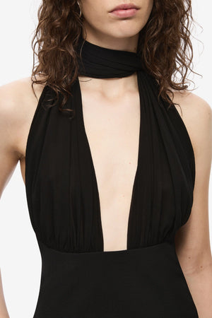 The Capezza Silk Top by MISHA, a plunging halter top with open back and wrap silk bodice. Perfect for sleek day-to-night styling.