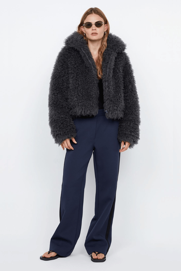 Argo Jacket Charcoal by Bec + Bridge – A chic charcoal faux fur bomber with wide collar, relaxed fit, front hook closure, and low waist finish. Fully lined. Dry clean only.